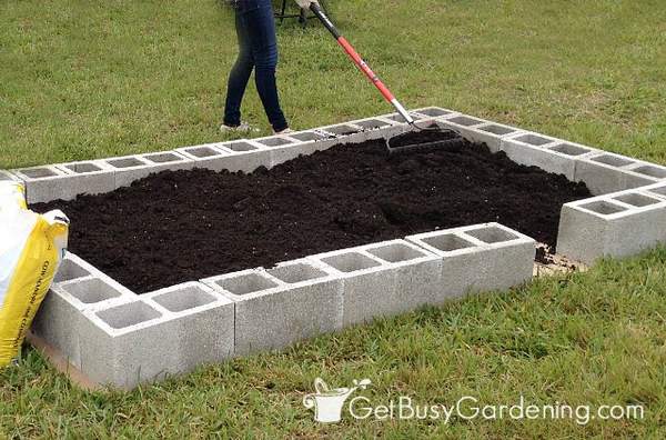 Filling the concrete block beds with soil