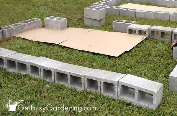 Laying cardboard under the cinder block raised beds