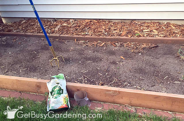 Top-dressing veggie garden bed before planting