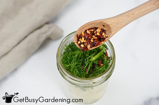 Adding herbs and spices to a jar