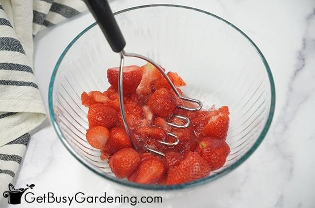 Mashing strawberries for canning jam
