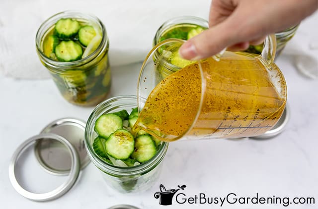 Pouring bread and butter pickle juice into the jars
