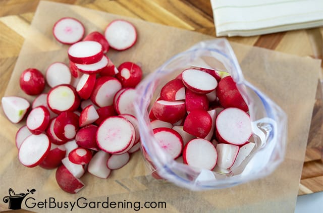 Filling a freezer bag with radishes
