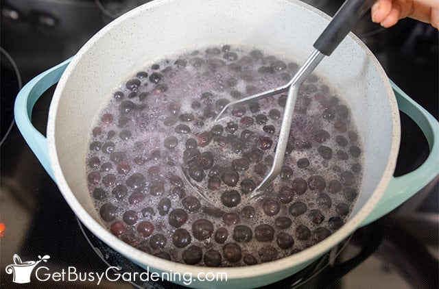Mashing blueberries as they cook