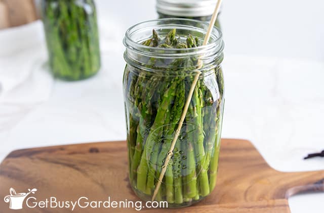 Popping air bubbles in a jar of asparagus