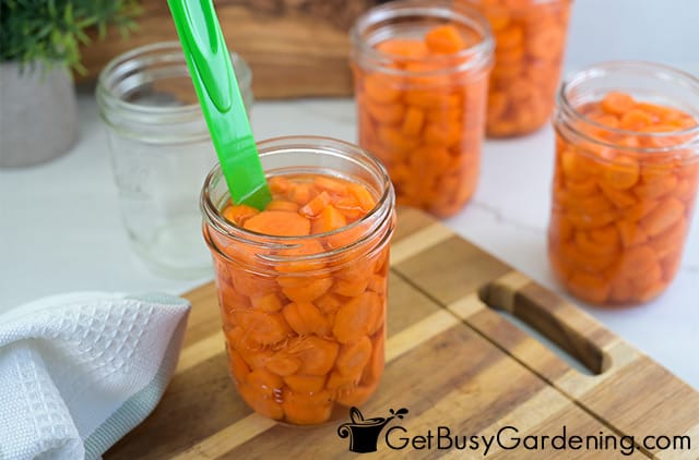 Popping air bubbles in a jar of carrots