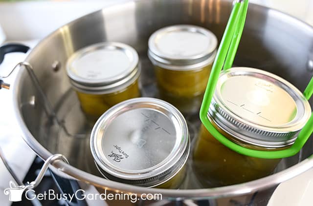 Removing jars of tomatillos from canner