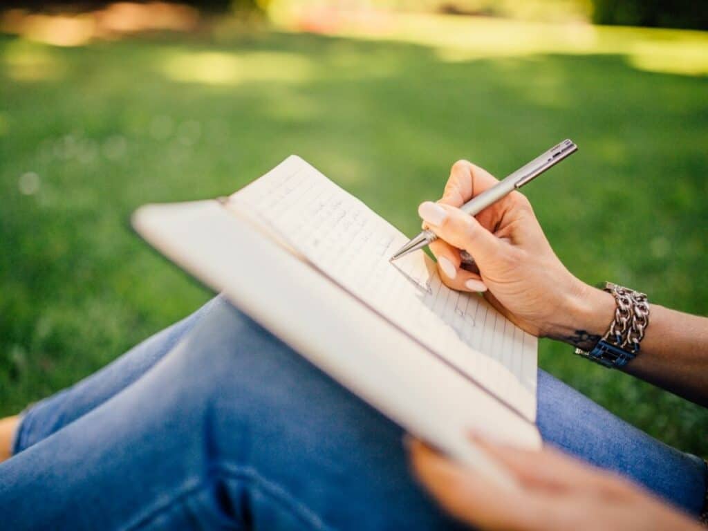 Person writing in a notebook.