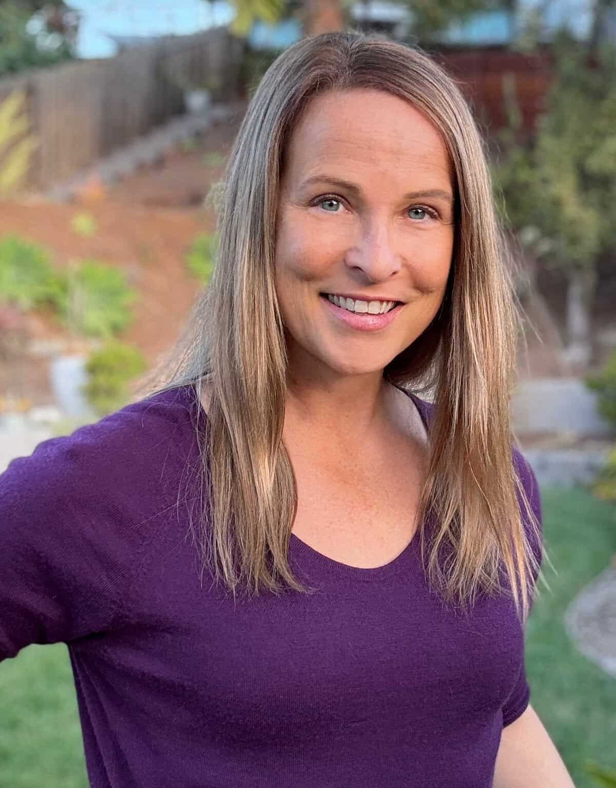 Amy Andrychowicz headshot purple shirt